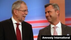 FILE - Norbert Hofer, right, candidate of Austria's Freedom Party, FPOE, talks to Alexander Van der Bellen, independent candidate, during the release of the first round of presidential election results in Vienna, Austria, April 24, 2016. Hofer conceded defeat Monday. 