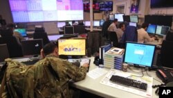 Staff operate at the NATO Computer Incident Response Capability (NCIRC) technical center, at NATO's military headquarters SHAPE in Mons, southwestern Belgium, Dec. 10, 2013.