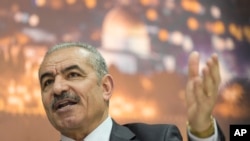 FILE - Palestinian Prime Minister Mohammad Shtayyeh italks during an interview with The Associated Press, at his office in the West Bank city of Ramallah, Apr. 16, 2019. 