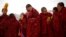 FILE - Tibetan monks attend a ceremony at the Langmu Lamasery during the "Sunbathing Buddha Festival", in Gannan Tibetan Autonomous Prefecture, Gansu Province, China, Feb. 17, 2019.