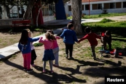 Children play in the yard of the Model National Nursery of Kallithea, in Athens, Greece, March 3, 2017.