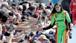 Driver Danica Patrick greets fans as she is introduced before the start of the Daytona 500 NASCAR Sprint Cup series auto race at Daytona International Speedway in Daytona Beach, Fla. Feb. 22, 2015