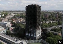 The scorched facade of the Grenfell Tower in London, June 15, 2017, after a massive fire raced through the 24-storey high-rise apartment building in west London early Wednesday.