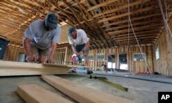 James Wheeler Jr., right, works to help rebuild his fishing business, Deep Sea Headquarters, in Port Aransas, Texas, Sept. 29, 2017.
