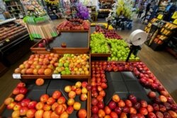 FILE - Apples are displayed for sale at the produce area as customers browse grocery store shelves inside Kroger Co.'s Ralphs supermarket in Los Angeles, California, U.S. March 15, 2020. REUTERS