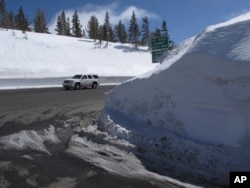 This photograph taken March 26, 2017, shows the record snow piled at the summit of the Mount Rose Highway (Nevada State Route 431) near the Mount Rose ski resort half way between Reno and Lake Tahoe. At an elevation of 8,911 feet, it is the highest highway pass open year-round in the Sierra Nevada.