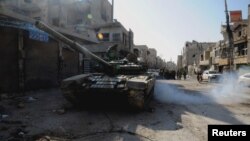 FILE - Soldiers loyal to Syria's President Bashar al-Assad are seen at Hujaira town, south of Damascus, after the soldiers took control of it from the rebel fighters, in this handout photograph distributed by Syria's national news agency SANA, Nov. 13, 2013.