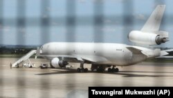 Zimbabwean armed soldiers patrol around a United States registered cargo plane at Harare International Airport in Harare, Zimbabwe, Monday, Feb,15.2016. (AP Photo/Tsvangirayi Mukwazhi)