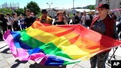 Georgian LGBT activists attend a rally against homophobia outside the State Chancellery to mark international day against homophobia in Tbilisi, Georgia. 