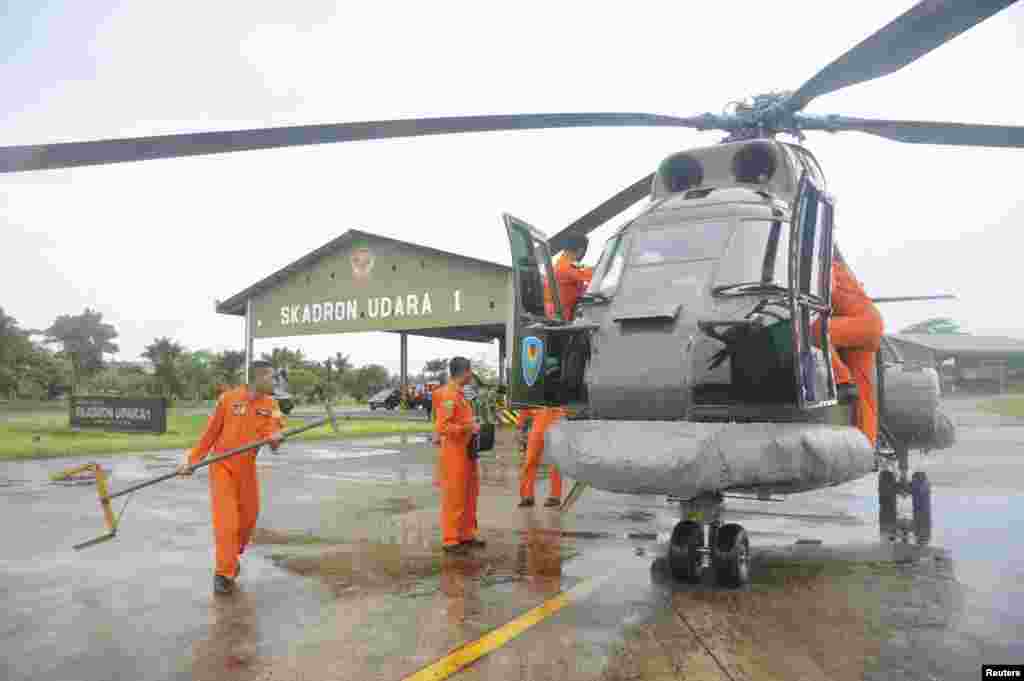 A search and rescue squad from the Indonesian Airforce prepare to depart on a Puma helicopter to take part in the search for the missing AirAsia Flight QZ8501, from a base in Kubu Raya, West Kalimantan, Dec. 28, 2014, in this photo taken by Antara Foto.
