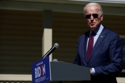 FILE - Joe Biden makes a statement about health care outside St. James-Santee Family Health Center in McClellanville, S.C., Feb. 27, 2020.
