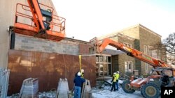 FILE - Workers begin demolition Jan. 17, 2023, at the Tree of Life building in Pittsburgh, the site of the deadliest antisemitic attack in U.S. history, as part of the effort to reimagine the building to honor the 11 people who were killed there in 2018.