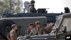 British troops stand near their vehicles after crossing the border from Bulgaria in Giurgiu, Romania, June 1, 2017 to take part in the alliance's Noble Jump 2017 exercise.