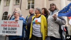 People gather in front of the European Union office to protest the government's judiciary policy, in Warsaw, Poland, June 26, 2018. Poland faces questions from its EU partners over an overhaul of its judicial system.
