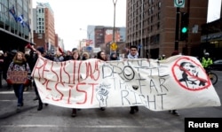 Protesters march against U.S. President Donald Trump in downtown Montreal, Canada, Jan. 20, 2017.