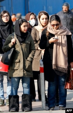 Iranian women wearing hijab walk down a street in the capital Tehran, Feb. 7, 2018. A spate of protests against Iran's mandatory headscarves for women have been few but have reignited a debate that has preoccupied the Islamic republic since its founding.