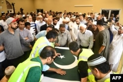The coffin of Santa Fe High School shooting victim Sabika Sheikh, 17, is carried during her funeral service in Stafford, Texas, May 20, 2018.