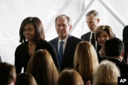 First lady Michelle Obama, from left, former President George W. Bush and Laura Bush leave the funeral service for former first lady Nancy Reagan at the Ronald Reagan Presidential Library in Simi Valley, California, March 11, 2016.