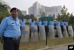 Pakistani police officers stand guard outside the supreme court in Islamabad, Pakistan, Oct. 31, 2018.