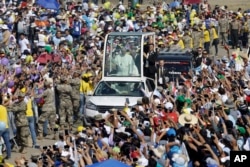 Pope Francis waves from his pope mobile as arrives to celebrate Mass on Huanchaco Beach, near the city of Trujillo, Peru, Jan. 20, 2018.