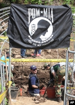 Bob Wood, Garden Valley, Calif., a members of the JPAC, Joint POW/MIA Accounting Command, bottom center, works as he digs to search for remains of U.S. soldiers killed during the 1950-53 Korean War in Hwacheon, South Korea, May 18, 2009.