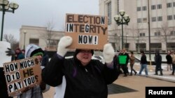 FILE - Members of the Green Party rally in support of continuing the recount of the U.S. presidential ballots in Lansing, Mich., Dec. 8, 2016.