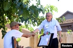 FILE - Former Sheriff Joe Arpaio campaigns in his bid to become the Republican nominee for an open U.S. Senate seat in Wickenburg, Arizona, Aug. 24, 2018.