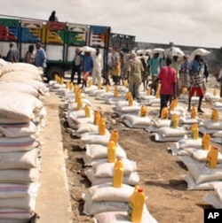Relief workers prepare to distribute food-aid rations at a camp for the internally displaced in Mogadishu.