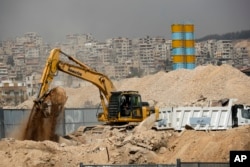 FILE - Heavy equipment works at a building site in southwestern Damascus, Syria, Oct. 8, 2018.