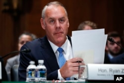 FILE - Interior Secretary Ryan Zinke arrives for a Senate Appropriations subcommittee hearing on the fiscal 2019 budget on Capitol Hill in Washington, May 10, 2018.