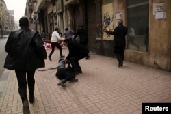 Activist Shaimaa Sabbagh is shown collapsed on the ground after she was shot during a protest in Cairo, Jan. 24, 2015.