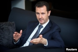 Syrian President Bashar al-Assad gestures during an interview in Damascus in this in this handout photo distributed by Syria's national news agency SANA on September 2, 2013.