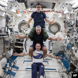 Russia’s Alexander Misurkin, bottom, NASA’s Mark Vande Hei, middle, and NASA’s Joe Acaba at the International Space Station, Feb. 25, 2018. The three astronauts flew back to Earth Tuesday, following a nearly six-month mission at the International Space S