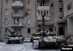 FILE - Tanks are seen in the government-held industrial town of Avdiyivka, Ukraine, Feb. 2, 2017.