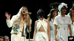 Kesha singing "Praying" while singers Camila Cabello, center, and Andra Day stand by at the 60th annual Grammy Awards at Madison Square Garden on Sunday, Jan. 28, 2018, in New York.