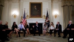 President Donald Trump hosts a listening session with high school students, teachers and parents in the State Dining Room of the White House in Washington, Wednesday, Feb. 21, 2018. (AP Photo/Carolyn Kaster)