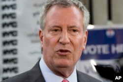 New York Mayor Bill de Blasio talks to the press after voting in the Democratic primary, Sept. 12, 2017 in the Brooklyn borough of New York.