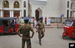 Sri Lankan policemen stand guard outside a mosque before the Friday prayers, in Colombo, Sri Lanka, April 26, 2019.