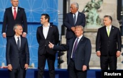 NATO Secretary General Jens Stoltenberg, Poland's President Andrzej Duda, Greek Prime Minister Alexis Tsipras, U.S. President Donald Trump, Portugal's Prime Minister Antonio Costa, Hungarian Prime Minister Viktor Orban pose for a group photo at NATO meeting.