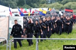 FILE - Police are seen during one of Germany's biggest right-wing music festivals in Themar, Germany, July 15, 2017.