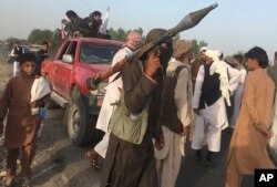 FILE - Taliban fighters gather in Surkhroad district of Nangarhar province, east of Kabul, Afghanistan.