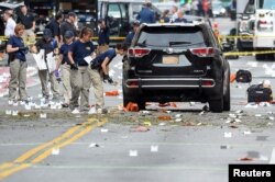 FILE - Federal Bureau of Investigation (FBI) officials label and collect evidence near the site of an explosion which took place on Saturday night in the Chelsea neighborhood of Manhattan, New York, Sept. 18, 2016.
