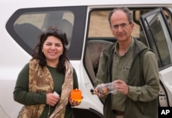 FILE - Undated photo provided by the family of the late Iranian-Canadian professor Kavous Seyed-Emami, shows him and his wife, Maryam Mombeini in an unidentified place in Iran.
