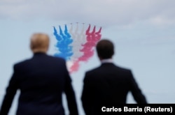 FRANCE -- U.S. President Donald Trump and French President Emmanuel Macron look to flypasts in the Normandy American Cemetery to commemorate the 75th anniversary of the D-Day landings, Normandy. June 6, 2019