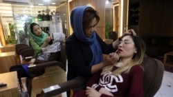 Beauticians apply makeup on customers at Ms. Sadat’s Beauty Salon in Kabul, Afghanistan, Sunday, April 25, 2021. Kabul's young working women say they fear their dreams may be short-lived if the Taliban return to Kabul, even if peacefully as part of a new
