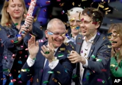 Green Party's gay rights activist Volker Beck (center) and fellow faction members celebrate with a confetti popper after German Federal Parliament, Bundestag, voted to legalize same-sex marriage in Berlin, Germany, June 30, 2017.