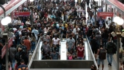 Dozens of passengers walk after disembarking from the train at Luz station in central Sao Paulo, Brazil, on March 5, 2021, amid the novel coronavirus COVID-19 pandemic. (AFP)