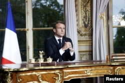 French President Emmanuel Macron addresses the French nation following a massive fire at Notre Dame Cathedral, at the Elysee Palace in Paris, France, 16 April 2019.