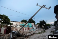 Buildings destroyed by an earthquake that struck off the southern coast of Mexico late on Thursday are seen on a street in Juchitan, Mexico, Sept. 8, 2017.