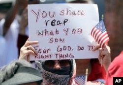 A demonstrator holds a sign during a protest outside the U.S. Border Patrol Central Processing Center, in McAllen, Texas, June 23, 2018.